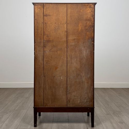 fig 5. An 18th-century Georgian dark mahogany standing cabinet featuring two tall recessed field-panel doors, a subtle curved apron, and square tapered legs.