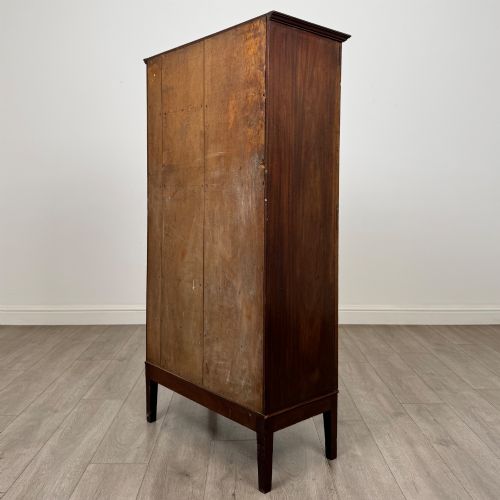 fig 6. An 18th-century Georgian dark mahogany standing cabinet featuring two tall recessed field-panel doors, a subtle curved apron, and square tapered legs.