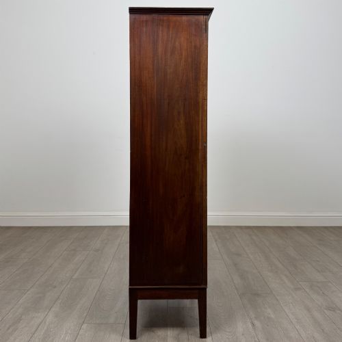 fig 7. An 18th-century Georgian dark mahogany standing cabinet featuring two tall recessed field-panel doors, a subtle curved apron, and square tapered legs.