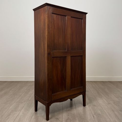 fig 8. An 18th-century Georgian dark mahogany standing cabinet featuring two tall recessed field-panel doors, a subtle curved apron, and square tapered legs.