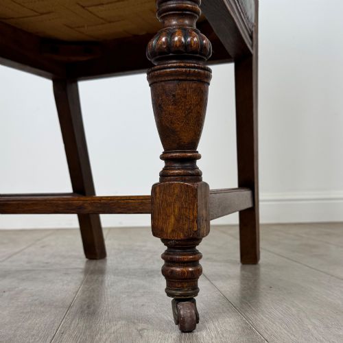 fig 5. A set of four 19th-century Victorian dark oak dining chairs featuring carved crest rails, turned legs, and light blue patterned fabric upholstery on the seats and backrests.