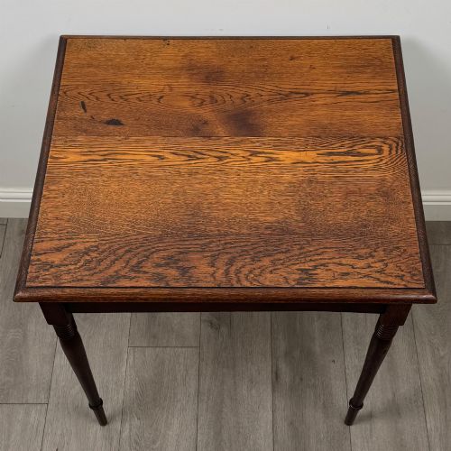 fig 8. An antique Edwardian dark oak side table featuring slender turned legs with ring details and a smooth square top surface.
