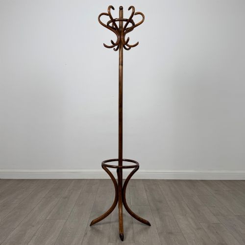 fig 1. A freestanding bentwood beech coat stand featuring curved upper hooks, a central umbrella ring, and splayed feet.