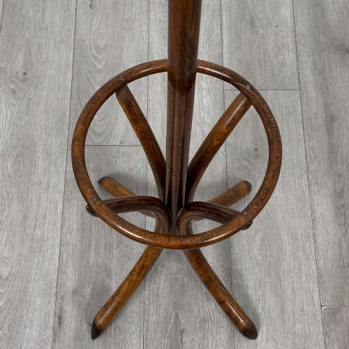fig 2. A freestanding bentwood beech coat stand featuring curved upper hooks, a central umbrella ring, and splayed feet.