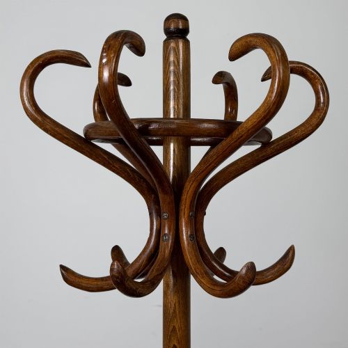 fig 3. A freestanding bentwood beech coat stand featuring curved upper hooks, a central umbrella ring, and splayed feet.