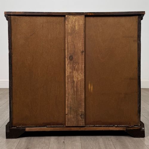 fig 4. An 18th-century dark oak Georgian chest of drawers featuring four graduated drawers with brass handles and keyhole escutcheons.