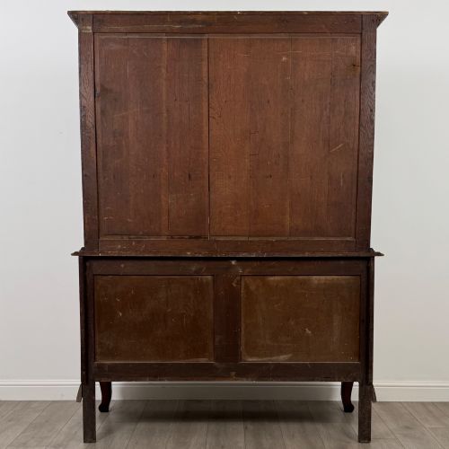 fig 5. A 20th-century golden oak Welsh dresser featuring a three-tiered open shelf top section over a two-door, two-drawer base with cabriole legs.