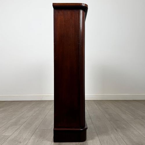 fig 7. An antique 19th-century Victorian mahogany open bookcase featuring four tier shelves, rounded front corners, and a solid plinth base.