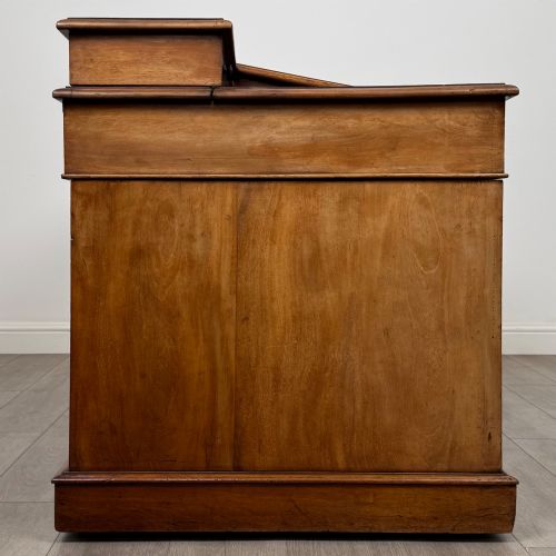 fig 6. A 19th-century Victorian mahogany Dickens desk featuring a sloped green leather writing top, a raised rear superstructure, and twin pedestals fitted with turned knobs.