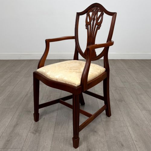 fig 1. A set of eight mahogany shield back dining chairs featuring intricate pierced back splats and light cream upholstered seats.