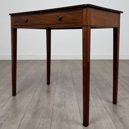 fig 1. An 18th-century Georgian mahogany writing table featuring a single drawer with brass handles and four square tapered legs.