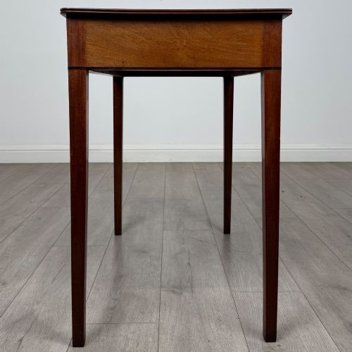 fig 2. An 18th-century Georgian mahogany writing table featuring a single drawer with brass handles and four square tapered legs.