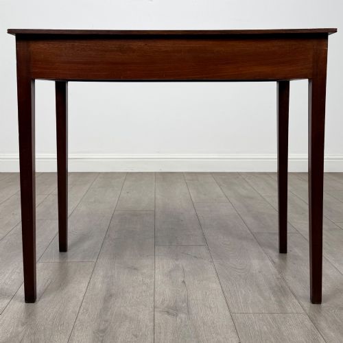 fig 4. An 18th-century Georgian mahogany writing table featuring a single drawer with brass handles and four square tapered legs.
