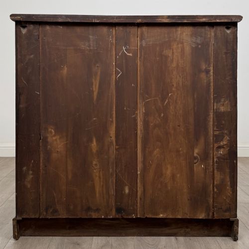 fig 4. An antique walnut chest of drawers featuring decorative brass handles, reeded top drawer fronts, and a solid plinth base.