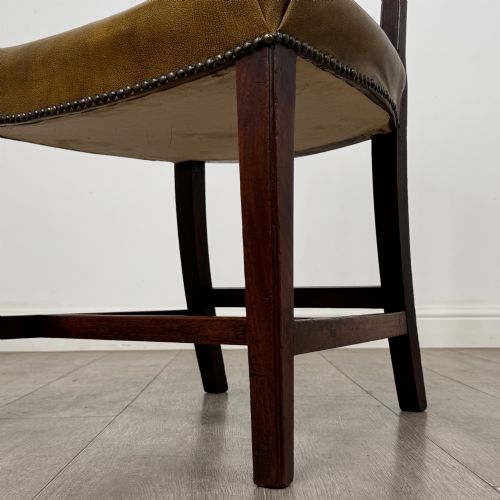 fig 4. A set of six antique mahogany dining chairs featuring vertical slat backs, square legs, and olive green leather seats finished with brass studs.