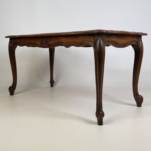 fig 1. A 20th-century dark oak coffee table featuring cabriole legs, a serpentine apron, and a central carved shell motif.