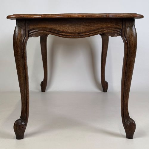 fig 2. A 20th-century dark oak coffee table featuring cabriole legs, a serpentine apron, and a central carved shell motif.