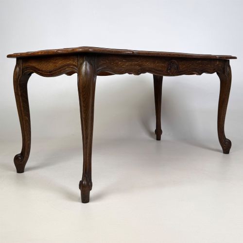 fig 3. A 20th-century dark oak coffee table featuring cabriole legs, a serpentine apron, and a central carved shell motif.