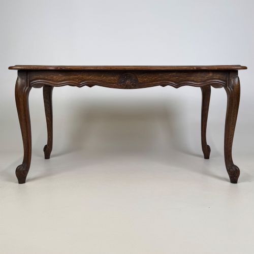 fig 4. A 20th-century dark oak coffee table featuring cabriole legs, a serpentine apron, and a central carved shell motif.