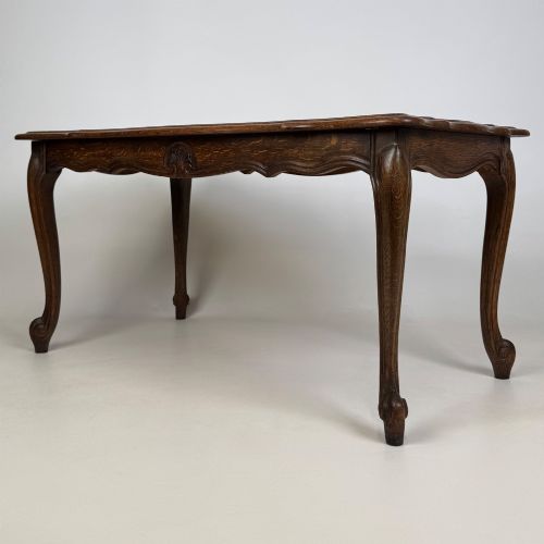 fig 5. A 20th-century dark oak coffee table featuring cabriole legs, a serpentine apron, and a central carved shell motif.