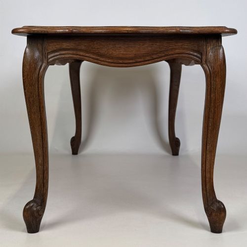fig 6. A 20th-century dark oak coffee table featuring cabriole legs, a serpentine apron, and a central carved shell motif.