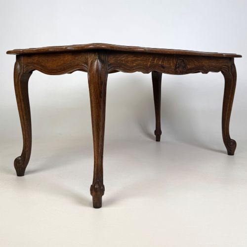 fig 7. A 20th-century dark oak coffee table featuring cabriole legs, a serpentine apron, and a central carved shell motif.