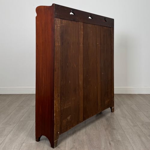 fig 4. An early 20th-century Arts and Crafts open walnut bookcase featuring four shelves and decorative pierced cut-outs on the top gallery and plinth base.