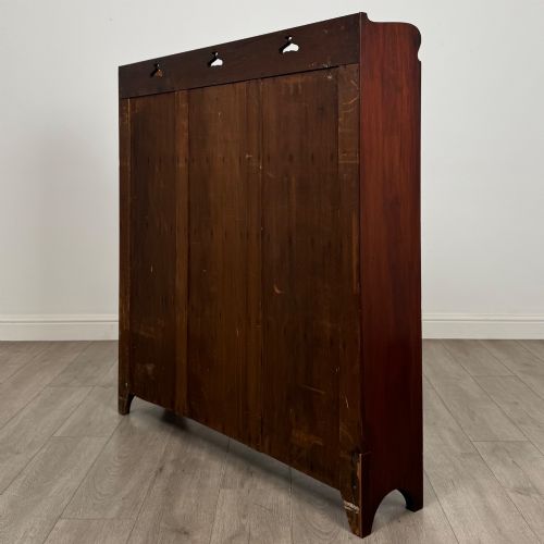fig 6. An early 20th-century Arts and Crafts open walnut bookcase featuring four shelves and decorative pierced cut-outs on the top gallery and plinth base.