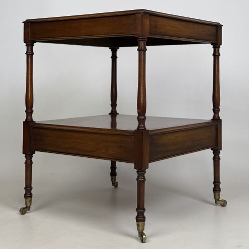 fig 6. A pair of 20th-century warm mahogany bedside tables featuring turned support pillars, open middle shelves, single lower drawers with brass handles, and brass castors.
