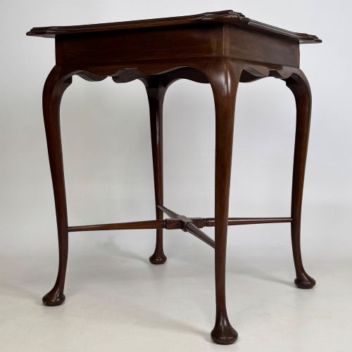 fig 1. An Edwardian mahogany side table featuring elegant cabriole legs, a shaped apron, and a central X-frame stretcher.