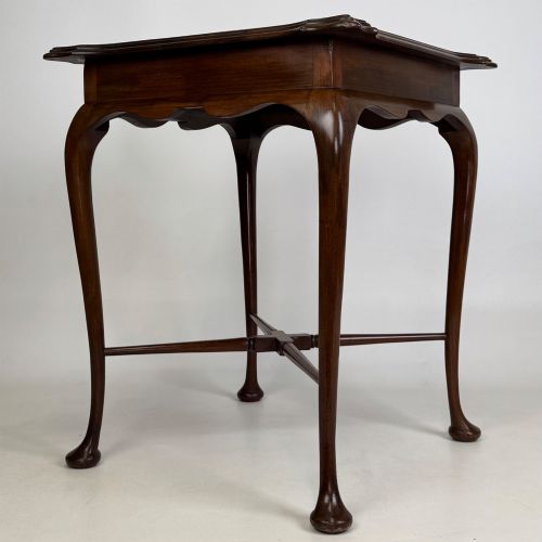 fig 3. An Edwardian mahogany side table featuring elegant cabriole legs, a shaped apron, and a central X-frame stretcher.