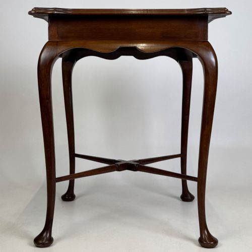 fig 4. An Edwardian mahogany side table featuring elegant cabriole legs, a shaped apron, and a central X-frame stretcher.