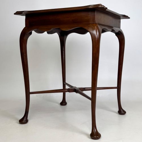 fig 5. An Edwardian mahogany side table featuring elegant cabriole legs, a shaped apron, and a central X-frame stretcher.