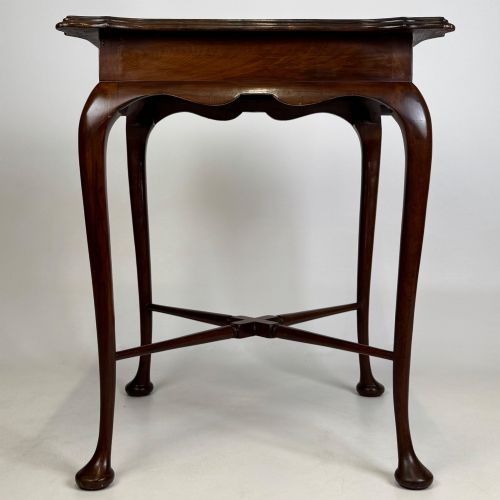 fig 6. An Edwardian mahogany side table featuring elegant cabriole legs, a shaped apron, and a central X-frame stretcher.