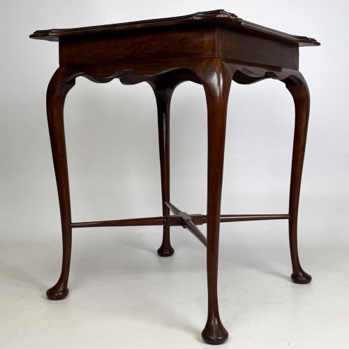 fig 7. An Edwardian mahogany side table featuring elegant cabriole legs, a shaped apron, and a central X-frame stretcher.