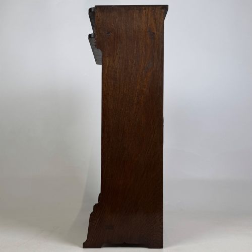 fig 3. A small Edwardian open bookcase crafted from dark oak timber featuring three open shelves and a shaped apron base.