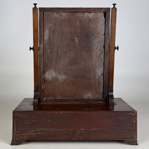 fig 4. An 18th-century Georgian mahogany dressing mirror featuring an adjustable rectangular tilting glass plate supported above a shaped box base containing three small drawers.