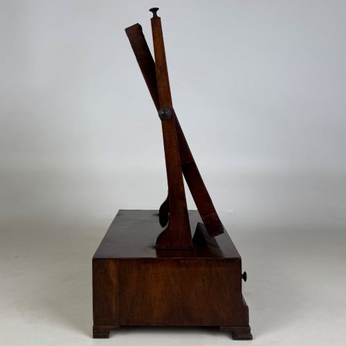 fig 7. An 18th-century Georgian mahogany dressing mirror featuring an adjustable rectangular tilting glass plate supported above a shaped box base containing three small drawers.