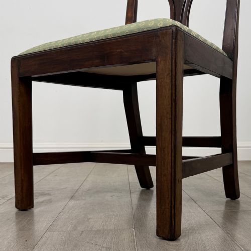 fig 4. A set of six Georgian mahogany dining chairs featuring intricate carved pierced splat backs, square legs, and light green patterned upholstered seats.