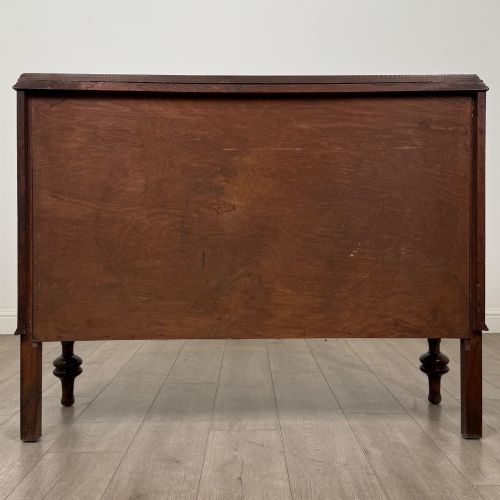 fig 5. A dark oak sideboard featuring two carved drawers above a double-door cupboard resting on turned legs.