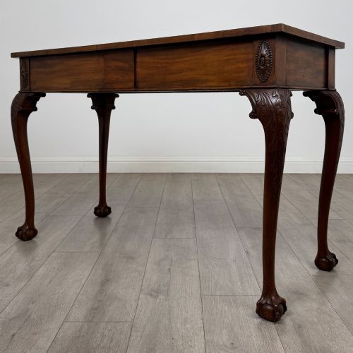 fig 1. A 19th-century Chippendale style mahogany side table featuring carved cabriole legs ending in ball and claw feet.
