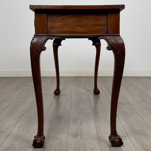fig 2. A 19th-century Chippendale style mahogany side table featuring carved cabriole legs ending in ball and claw feet.