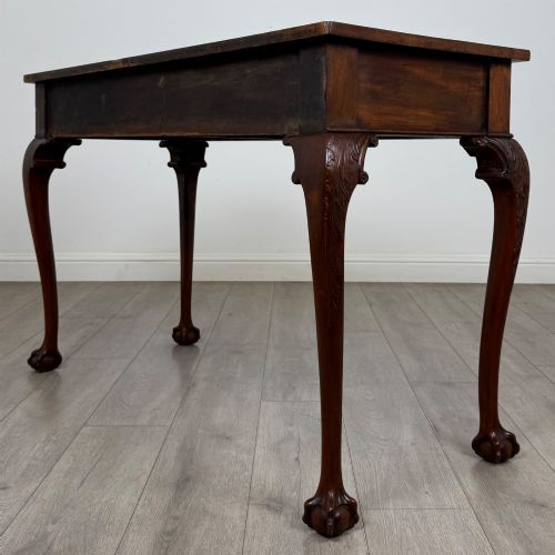 fig 5. A 19th-century Chippendale style mahogany side table featuring carved cabriole legs ending in ball and claw feet.