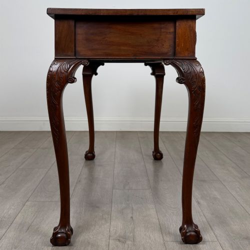 fig 6. A 19th-century Chippendale style mahogany side table featuring carved cabriole legs ending in ball and claw feet.