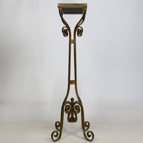 fig 3. A pair of tall gilded metal plant stands featuring incised leaf patterning, scrollwork legs, and square dark marble tops.