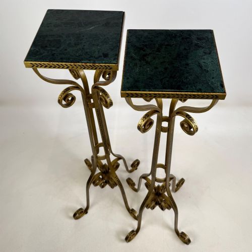fig 7. A pair of tall gilded metal plant stands featuring incised leaf patterning, scrollwork legs, and square dark marble tops.
