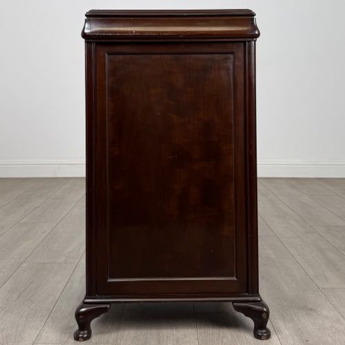fig 5. An early 20th-century dark mahogany cupboard featuring two panelled doors with small wooden turned knobs, keyhole escutcheon, and cabriole feet.