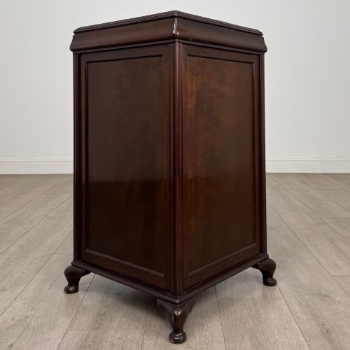fig 6. An early 20th-century dark mahogany cupboard featuring two panelled doors with small wooden turned knobs, keyhole escutcheon, and cabriole feet.