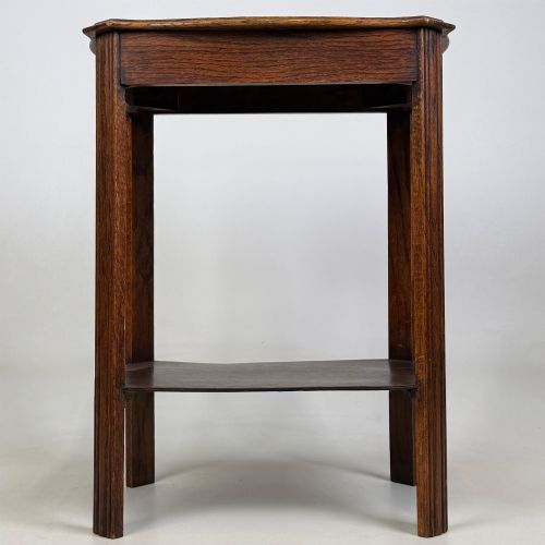 fig 4. An Edwardian dark oak side table featuring fluted legs, a moulded top, and a lower shelf tier.