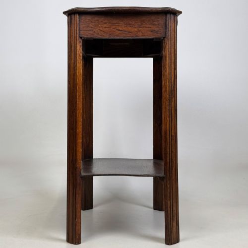 fig 6. An Edwardian dark oak side table featuring fluted legs, a moulded top, and a lower shelf tier.